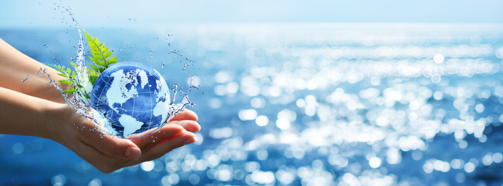 Environment Concept - Hands Holding Globe Glass In Blue Ocean With Defocused Lights