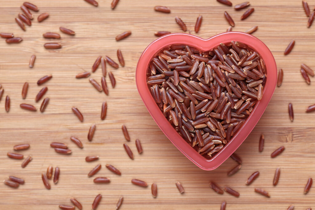 Red rice in a heart shape bowl riso rosso fermentato